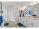 Bright primary bathroom with double vanity, ample counter space, and a step-in shower with glass doors at 2901 Monaghan Dr, Ormond Beach, FL 32174