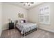 Bedroom with carpet, shuttered windows, ceiling fan, and a metal frame bed with patterned bedding at 2901 Monaghan Dr, Ormond Beach, FL 32174
