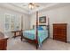 Comfortable primary bedroom with a four-poster bed, tray ceiling, plantation shutters and ample natural light at 2901 Monaghan Dr, Ormond Beach, FL 32174