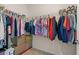 Walk-in closet with metal storage shelving filled with clothes, shoes, and cardboard boxes at 2901 Monaghan Dr, Ormond Beach, FL 32174