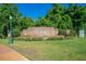 Welcoming entrance to Halifax Plantation with brick signage, lush landscaping, and street lighting at 2901 Monaghan Dr, Ormond Beach, FL 32174