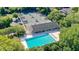 Aerial view of a community pool and tennis courts, perfect for recreation and relaxation at 2901 Monaghan Dr, Ormond Beach, FL 32174