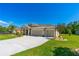 Exterior elevation showcasing the three-car garage and well-kept lawn at 2901 Monaghan Dr, Ormond Beach, FL 32174
