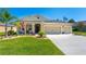 Charming front exterior with a well-manicured lawn and a three-car garage at 2901 Monaghan Dr, Ormond Beach, FL 32174