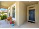 Inviting front porch with a bench, potted flowers, and a view of the landscaped yard at 2901 Monaghan Dr, Ormond Beach, FL 32174