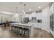 Bright kitchen boasts an island with seating, stainless appliances, and stylish white cabinets and countertops at 2901 Monaghan Dr, Ormond Beach, FL 32174