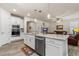 Open kitchen with island, granite countertops, stainless steel appliances, and seamless flow into living area at 2901 Monaghan Dr, Ormond Beach, FL 32174