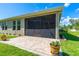 Covered and screened lanai with brick-paved patio, creating a comfortable outdoor living area at 2901 Monaghan Dr, Ormond Beach, FL 32174