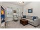 Comfortable living room with a neutral-toned sofa, patterned armchair, and shuttered windows at 2901 Monaghan Dr, Ormond Beach, FL 32174