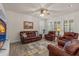 Bright living room with tile floors, a ceiling fan, and plantation shutters at 2901 Monaghan Dr, Ormond Beach, FL 32174