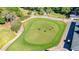 Manicured putting green on the golf course with players, offering a scenic recreational experience at 2901 Monaghan Dr, Ormond Beach, FL 32174