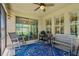 Relaxing screened porch with ceiling fan, seating, and sliding glass doors at 2901 Monaghan Dr, Ormond Beach, FL 32174