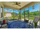 Spacious screened porch with lake views, seating area, ceiling fan, and tiled flooring at 2901 Monaghan Dr, Ormond Beach, FL 32174