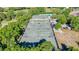 Expansive tennis courts and pool in a serene, tree-lined setting for active living at 2901 Monaghan Dr, Ormond Beach, FL 32174