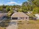 Aerial view of a charming single-story home with a well-manicured lawn and a spacious driveway at 3109 Sky St, Deltona, FL 32738