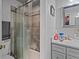 Shower area featuring glass enclosure and grey tiles with a vanity on the right at 3109 Sky St, Deltona, FL 32738