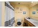 Bright bathroom featuring a vanity, framed mirror, and shower with a black and white striped curtain at 3109 Sky St, Deltona, FL 32738