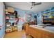 Bedroom with light blue walls, wooden flooring and personal items at 3109 Sky St, Deltona, FL 32738