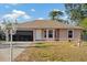 Charming single-story home featuring a two-car garage, well-maintained lawn, and decorative fountain at 3109 Sky St, Deltona, FL 32738