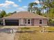 Charming single-story home featuring a two-car garage, well-maintained lawn, and decorative fountain at 3109 Sky St, Deltona, FL 32738