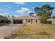 Inviting single-story home featuring a two-car garage, manicured lawn, and charming decorative fountain at 3109 Sky St, Deltona, FL 32738