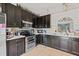 Traditional kitchen with stainless steel appliances and black cabinetry at 3109 Sky St, Deltona, FL 32738