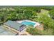 Aerial view showcasing a pool, tennis courts, and green spaces, creating a resort-like feel at 3140 Kailani Ct, Ormond Beach, FL 32174