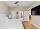 Bedroom with a white bed, ladder, TV, and a view into the bathroom and living room at 3140 Kailani Ct, Ormond Beach, FL 32174