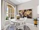 Bright dining area features a white table set, decorative artwork, and a view to the inviting outdoor space at 3140 Kailani Ct, Ormond Beach, FL 32174