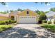 Lovely home featuring a bright facade, two-car garage, and green lawn at 3140 Kailani Ct, Ormond Beach, FL 32174