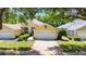 Charming yellow single-story home with a two-car garage, mature landscaping, and a well-manicured lawn at 3140 Kailani Ct, Ormond Beach, FL 32174
