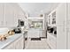 Spacious kitchen with stainless steel appliances, white cabinets, and an open layout offering a seamless flow at 3140 Kailani Ct, Ormond Beach, FL 32174