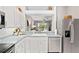 Kitchen with stainless steel appliances, sink, and breakfast bar overlooking the living area and backyard at 3140 Kailani Ct, Ormond Beach, FL 32174
