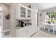Bright kitchen with white cabinets, coffee bar, and view of the dining area for easy entertaining and serving at 3140 Kailani Ct, Ormond Beach, FL 32174