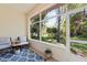 Enclosed lanai featuring a patterned rug and views of the lush greenery at 3140 Kailani Ct, Ormond Beach, FL 32174