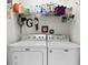 Bright laundry room with shelving for organizing supplies and modern appliances at 3140 Kailani Ct, Ormond Beach, FL 32174