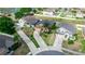 An aerial view shows multiple single Gathering homes with long driveways, well-kept lawns, and mature landscaping at 320 Conch Key Way, Sanford, FL 32771