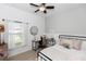 Inviting bedroom featuring a cozy bed, desk, and a window with natural light at 320 Conch Key Way, Sanford, FL 32771
