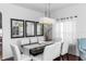 Dining room featuring a modern chandelier, a dark wood table, and six chairs at 320 Conch Key Way, Sanford, FL 32771