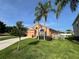 Beautiful home exterior with lush landscaping and palm trees at 320 Conch Key Way, Sanford, FL 32771