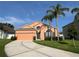 Inviting home exterior with a well-kept lawn, mature trees, and a paved driveway at 320 Conch Key Way, Sanford, FL 32771