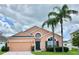 Charming one-story home with a well-manicured lawn and inviting curb appeal with beautiful palm trees at 320 Conch Key Way, Sanford, FL 32771