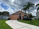 Single Gathering home with a large driveway and well maintained lawn and landscaping at 320 Conch Key Way, Sanford, FL 32771