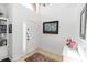 Bright foyer featuring tile flooring, fresh white paint, a nautical painting, and a decorative rug at 320 Conch Key Way, Sanford, FL 32771