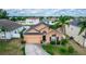 Charming one-story home featuring an attached garage, well-maintained lawn, and mature palm tree landscaping at 320 Conch Key Way, Sanford, FL 32771