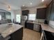 Modern kitchen featuring stainless steel appliances, granite countertops, and a convenient island with breakfast bar at 320 Conch Key Way, Sanford, FL 32771