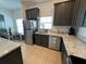 Bright kitchen featuring stainless steel appliances, granite countertops, and eat-in breakfast nook at 320 Conch Key Way, Sanford, FL 32771