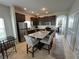 Bright kitchen featuring stainless steel appliances, granite countertops, and a functional island with seating at 320 Conch Key Way, Sanford, FL 32771