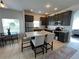 Stylish kitchen with stainless steel appliances, a granite island with seating, and a tiled floor at 320 Conch Key Way, Sanford, FL 32771