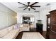 Spacious living room open to the kitchen, featuring hardwood floors and a comfortable sectional sofa at 320 Conch Key Way, Sanford, FL 32771